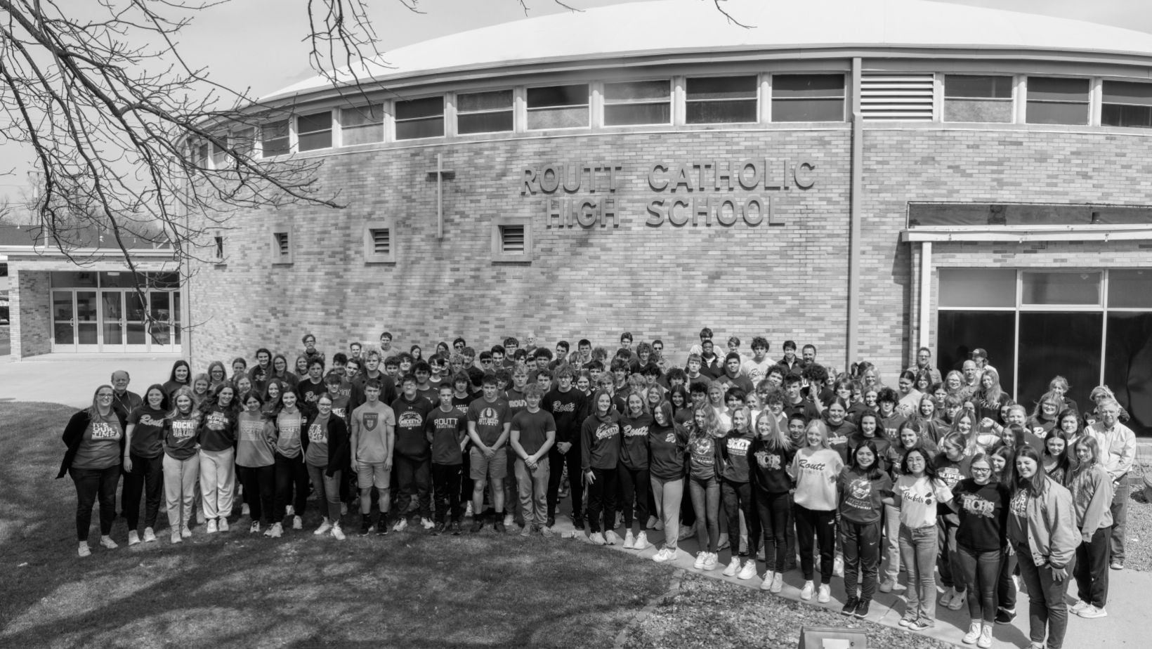 Routt Catholic High School gymnasium outdoors with students standing in front
